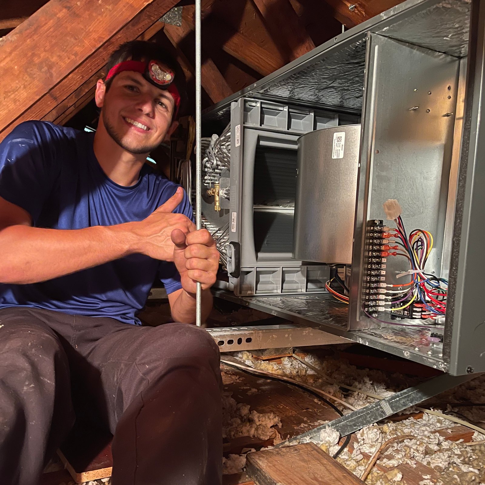 Close-up of a white ductless mini-split AC unit mounted on the wall